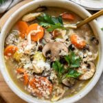 Creamy Turkey Wild Rice Soup in a white bowl with a spoon.