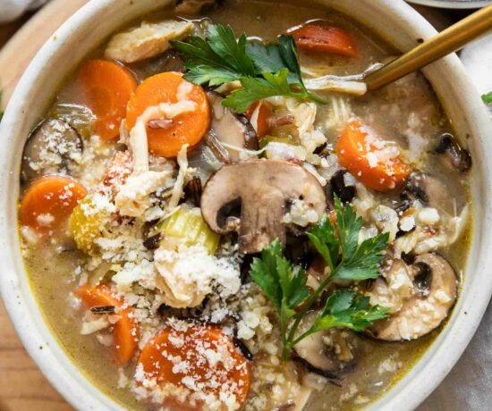 Creamy Turkey Wild Rice Soup in a white bowl with a spoon.