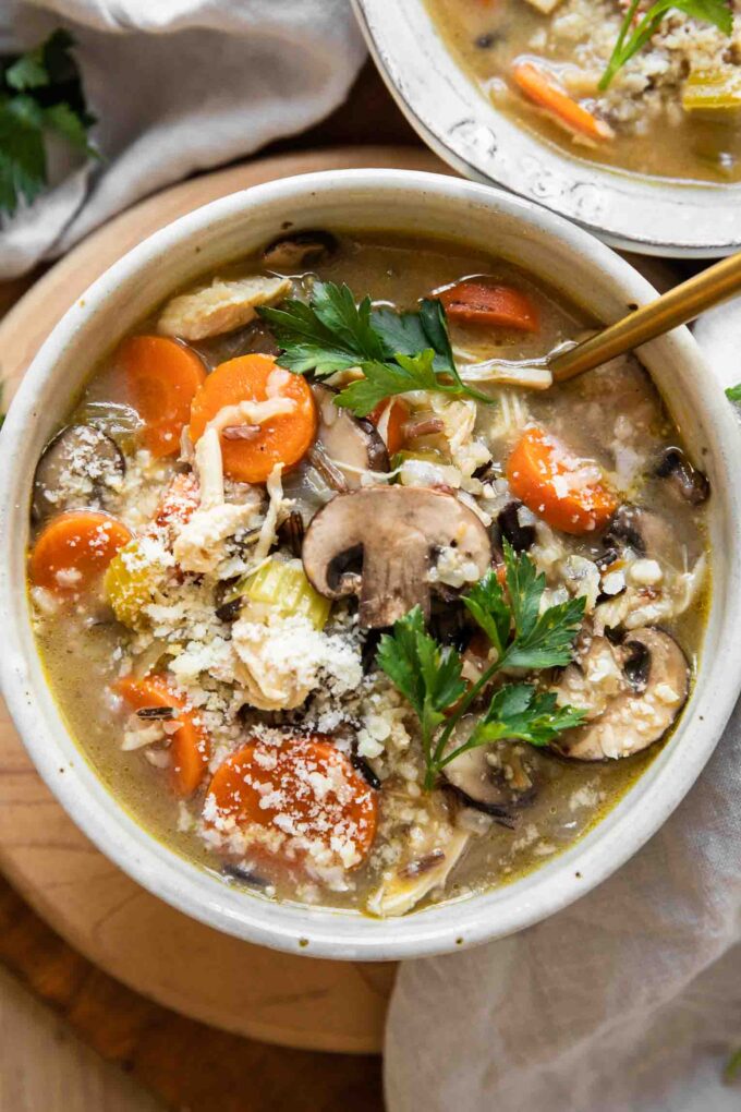Creamy Turkey Wild Rice Soup in a white bowl with a spoon.