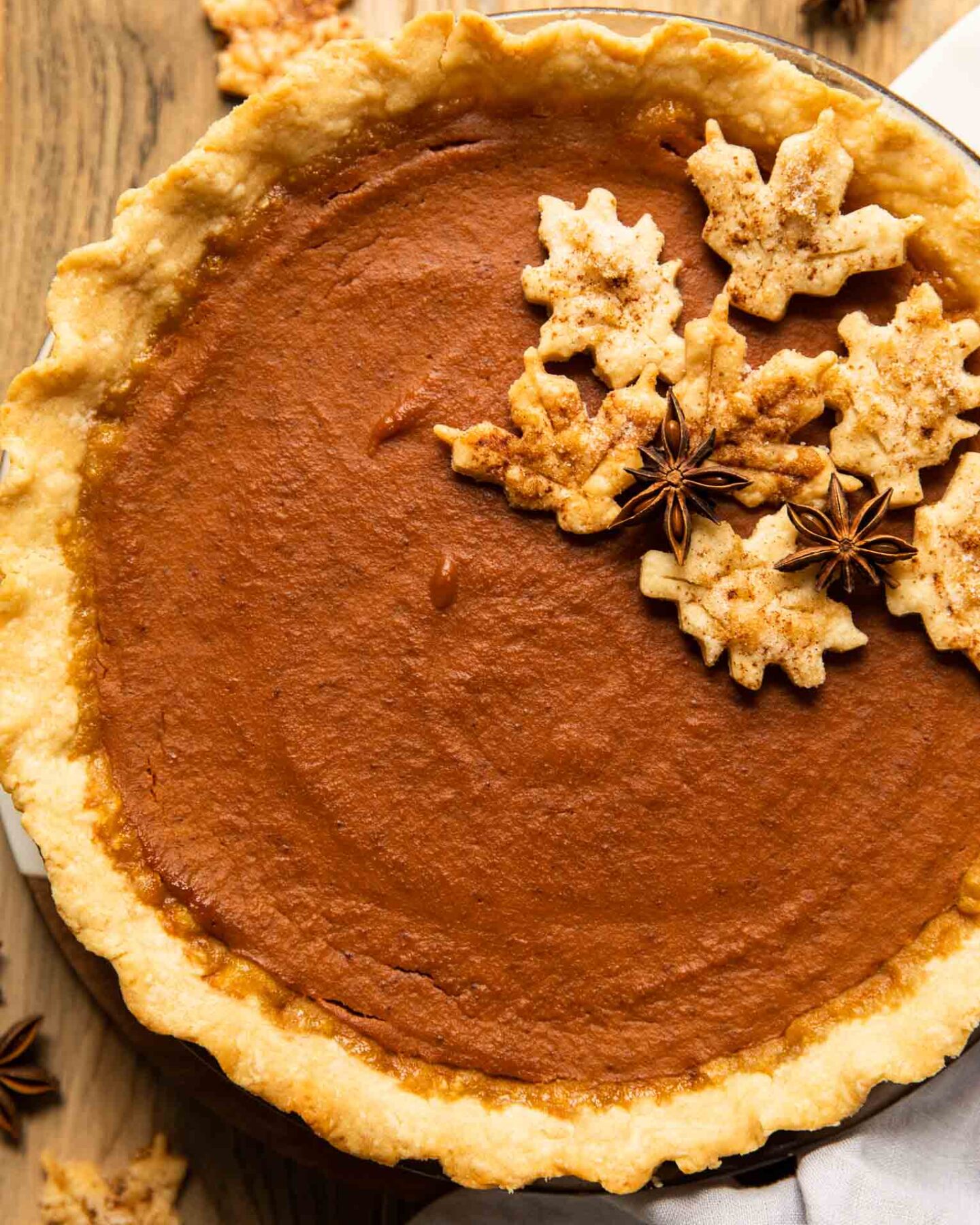 Top shot of dairy free pumpkin pie on a wood table.
