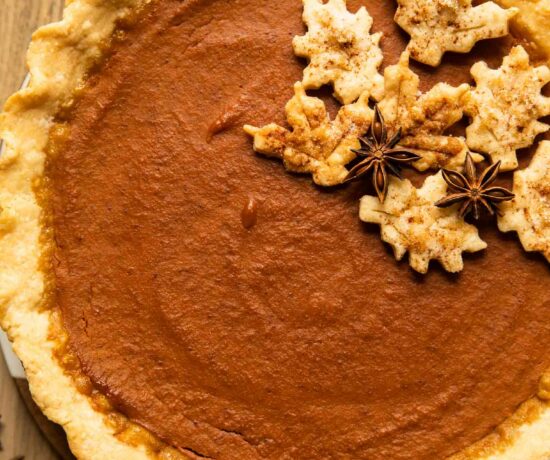 Top shot of dairy free pumpkin pie on a wood table.