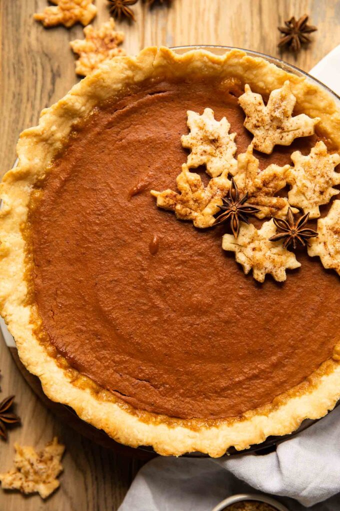 Top shot of dairy free pumpkin pie on a wood table.