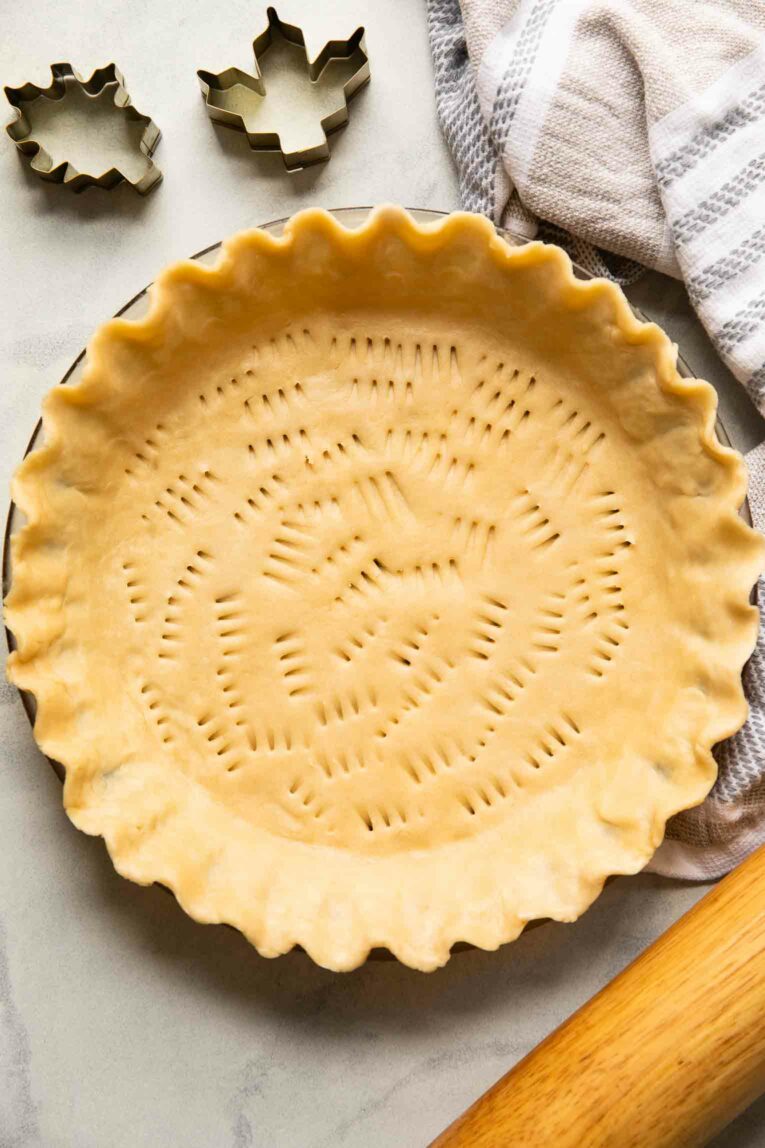 Uncooked vegan pie crust in a pan.