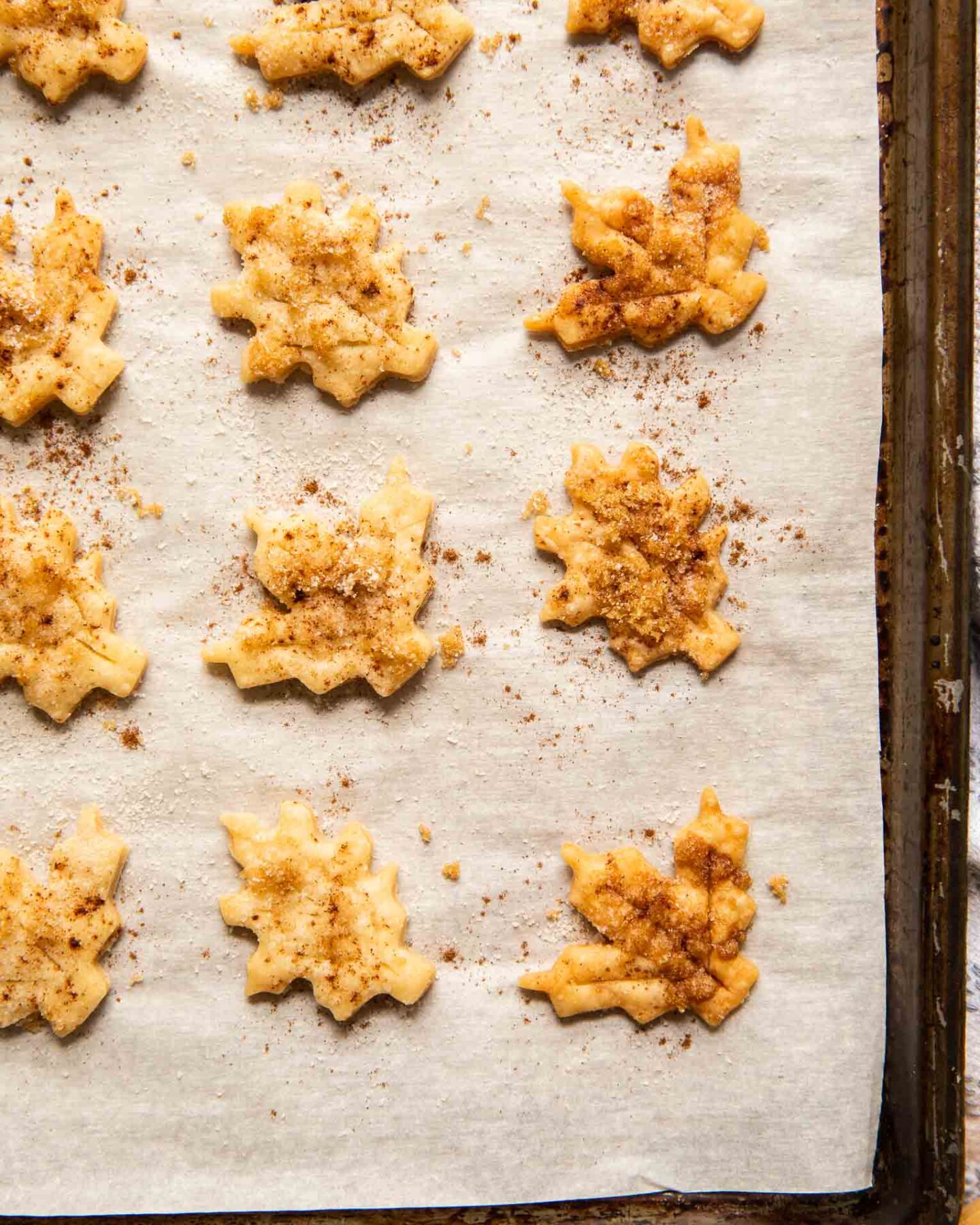 Close up of pie crust cookies on a baking sheet.