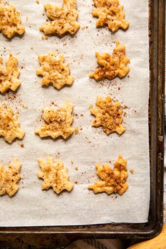 Close up of pie crust cookies on a baking sheet.