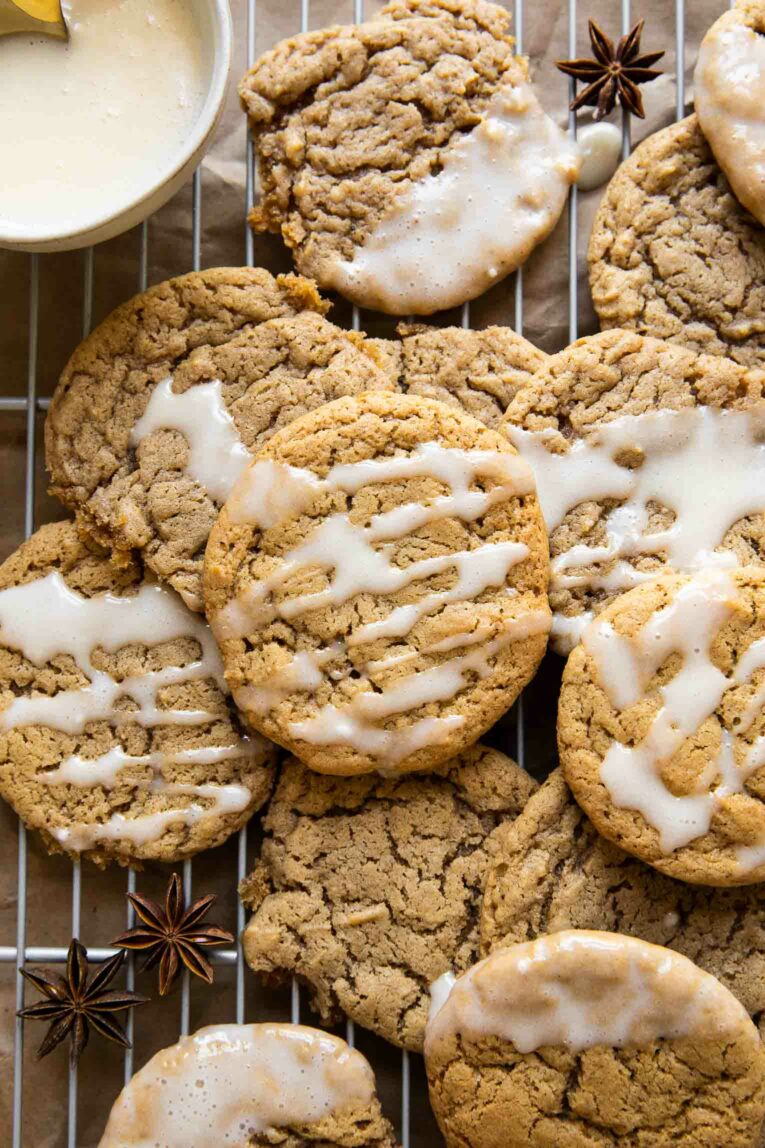 Close up of spiced eggnog cookies with a white eggnog icing drizzle.