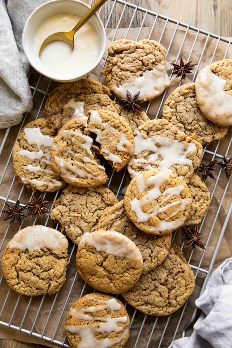 Spiced eggnog cookies on a cooling rack with icing.