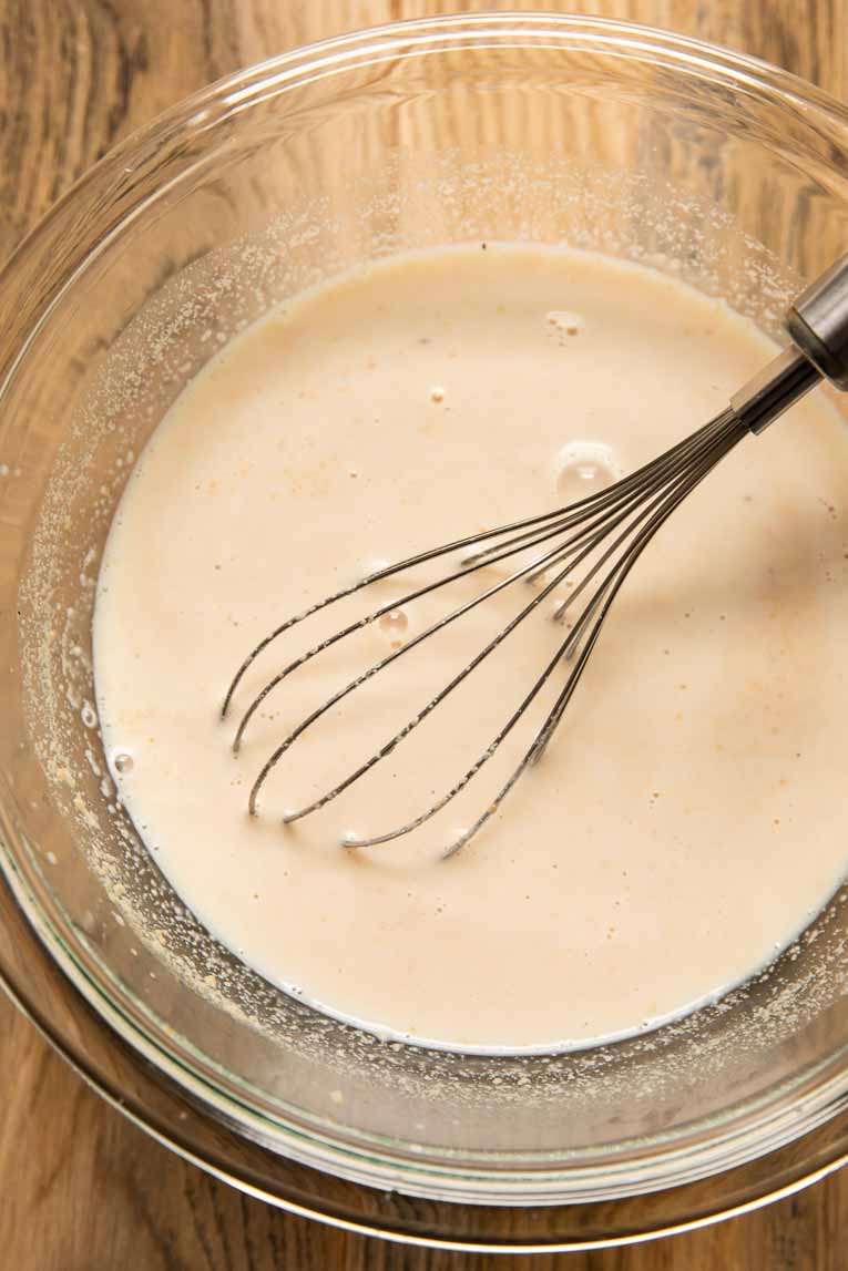 Vegan creamy cashew sauce being whisked together.