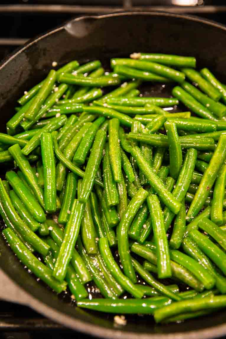 Green beans being steamed in a pot.