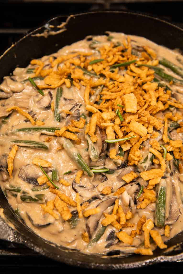 Vegan green bean casserole being cooked in a skillet.