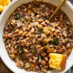 Instant Pot Black Eyed Peas with cornbread, bacon, and vegetables.