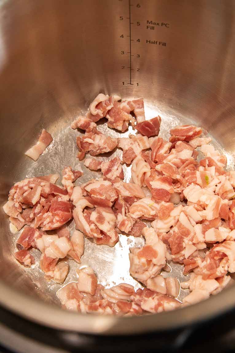 Bacon being sautéed in an Instant Pot.