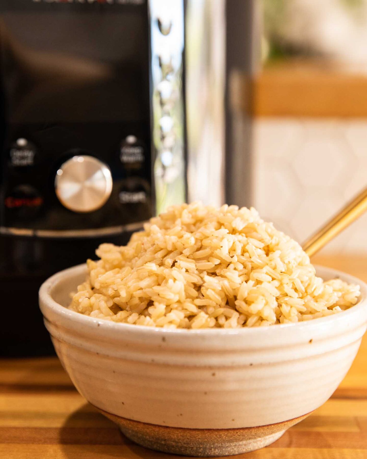 Instant Pot Cooked Brown Rice in a bowl with a fork.