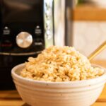 Instant Pot Cooked Brown Rice in a bowl with a fork.