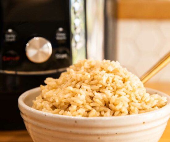 Instant Pot Cooked Brown Rice in a bowl with a fork.