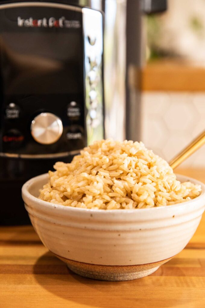 Instant Pot Cooked Brown Rice in a bowl with a fork.