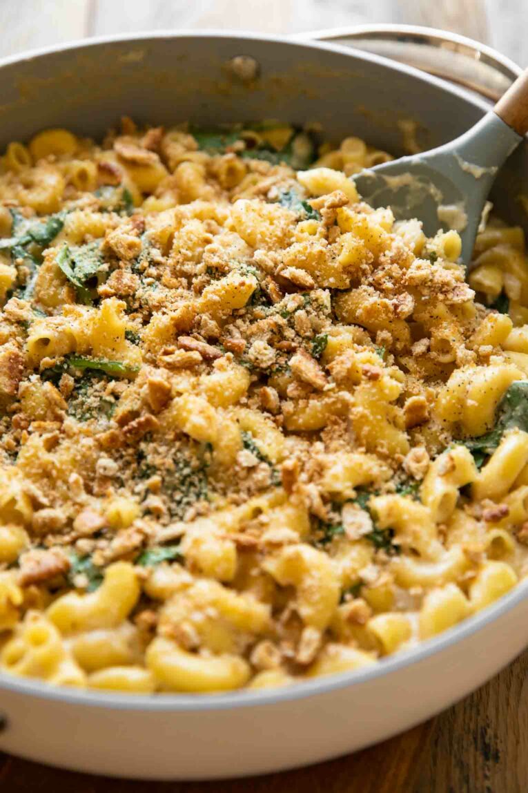 Angled photo of Spinach Ricotta Mac & Cheese with a serving spoon.