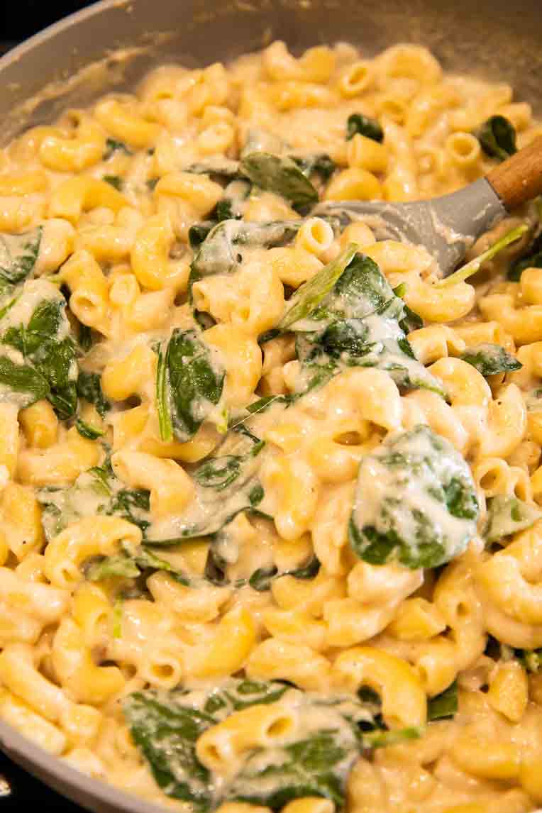 Mac and cheese made with ricotta and spinach being cooked.