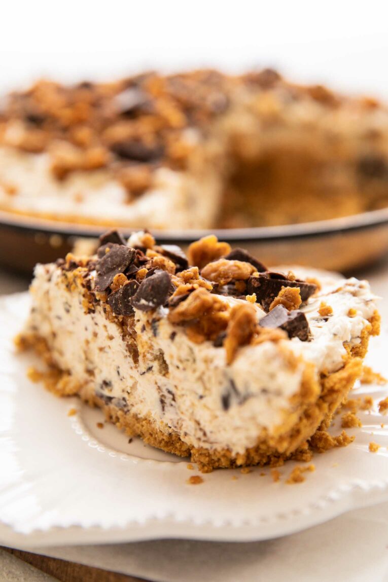 Slice of vegan butterfinger cheesecake on a white plate.