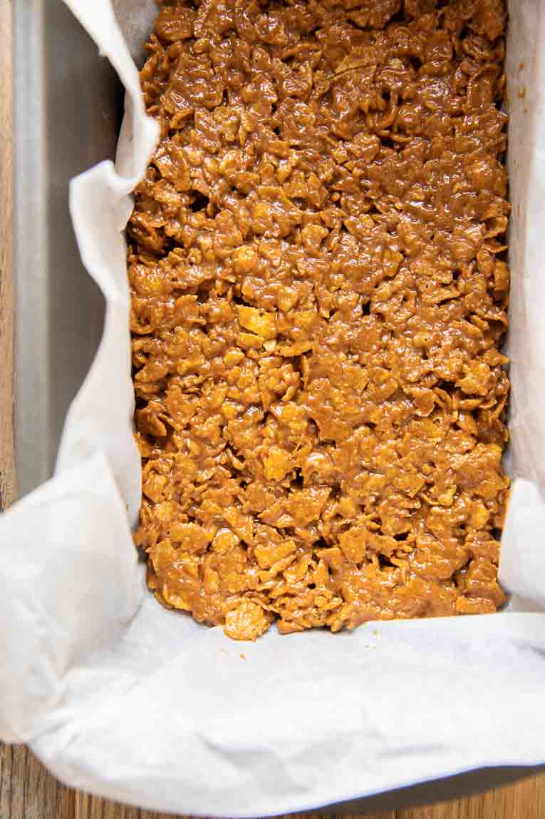 Vegan butterfingers being made in a loaf pan.