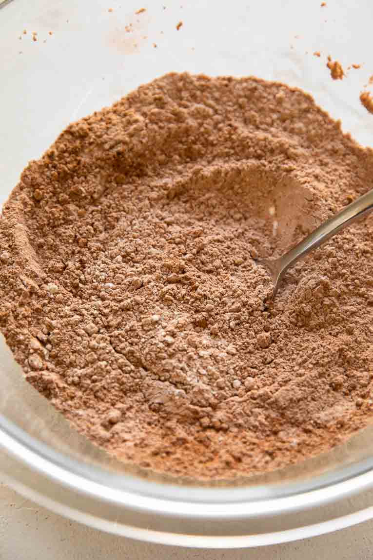 Chocolate cookie dry ingredients being mixed together.