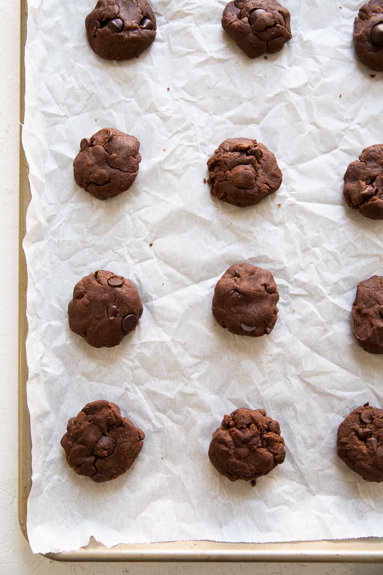 Vegan double chocolate chip cookie dough on a baking sheet.