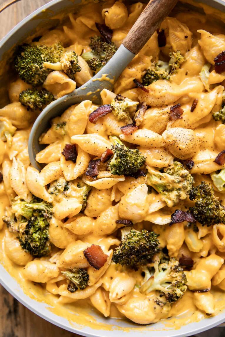 Close up of Butternut Squash Mac & Cheese in a pan with a spoon.