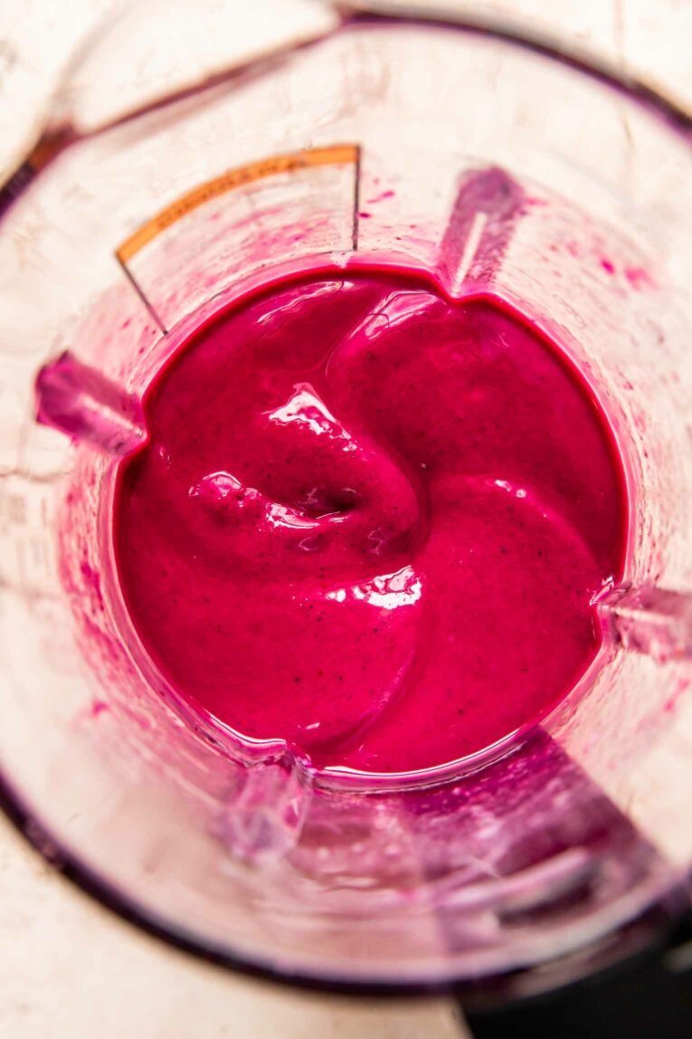 Dragon Fruit smoothie being blended in a blender.