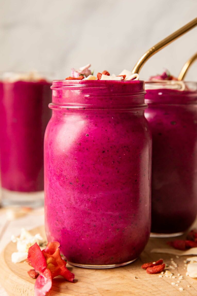 Across photo of Goji berry smoothie in a mason jar with a straw.