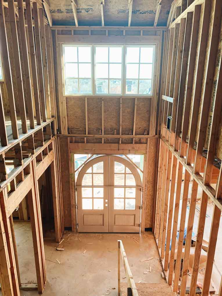Arched wood door in entryway.