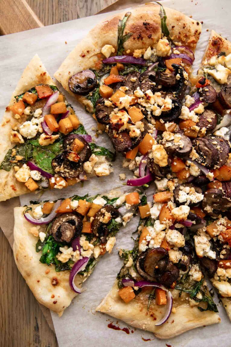 Sliced vegetarian hot honey pizza with toppings.