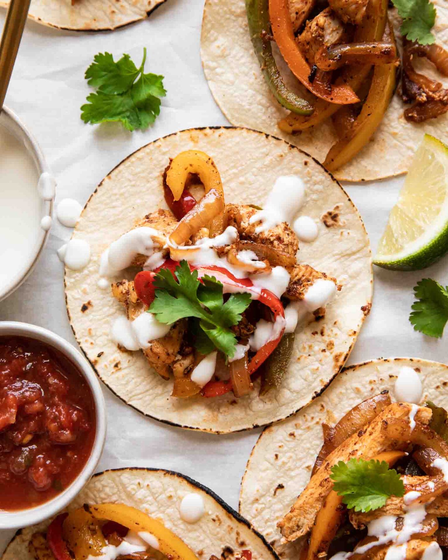 The BEST Chicken Fajita Tacos with a cream sauce and cilantro.