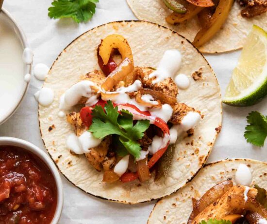 The BEST Chicken Fajita Tacos with a cream sauce and cilantro.