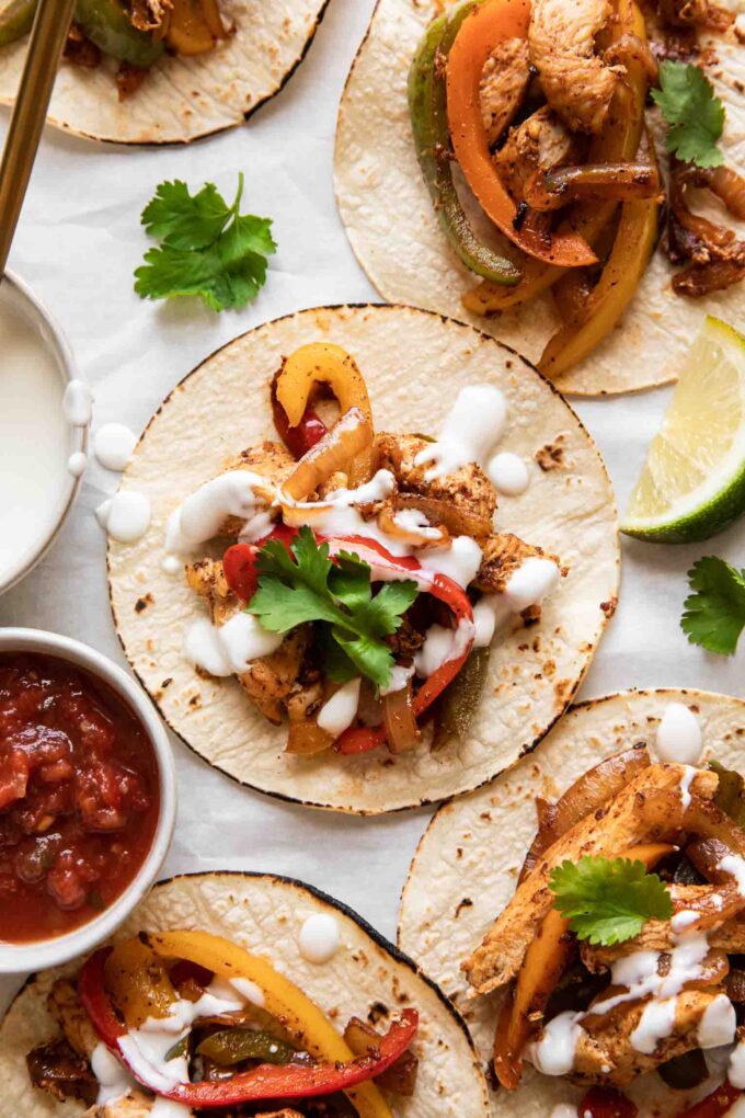 The BEST Chicken Fajita Tacos with a cream sauce and cilantro.