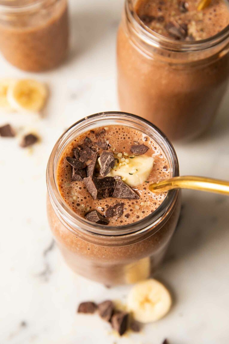 Top shot photo of a chocolate banana smoothie with bananas and chocolate chunks.