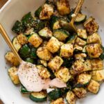 Crispy Air Fryer Zucchini in a bowl with yogurt sriracha sauce.