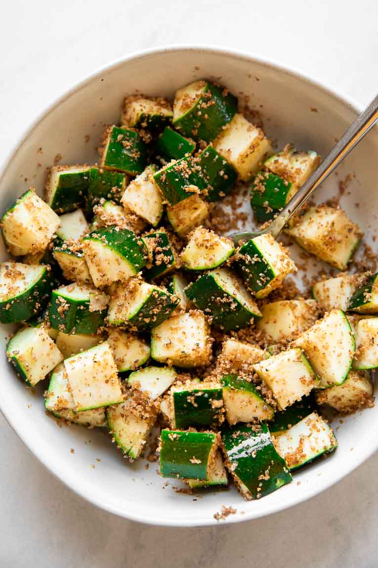 Raw zucchini tossed in oil and seasoning.