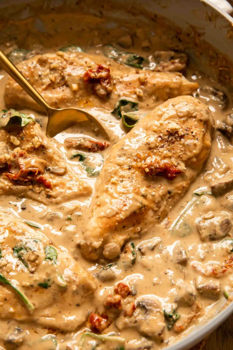 Angled photo of healthy tuscan chicken recipe in a pan.