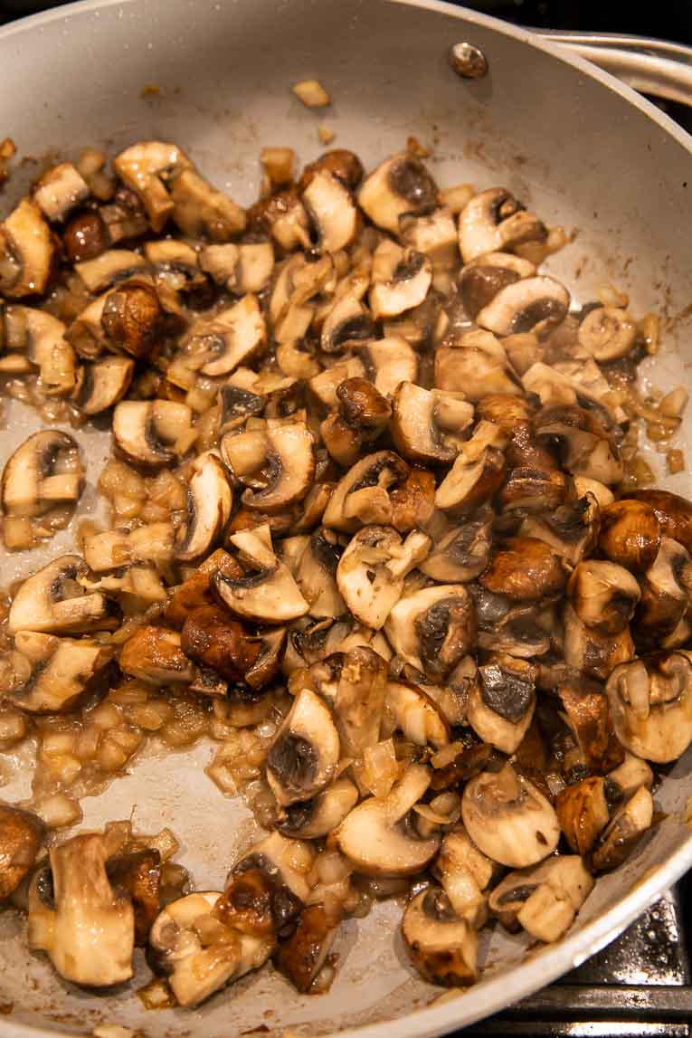 Mushrooms being cooked in a pan.