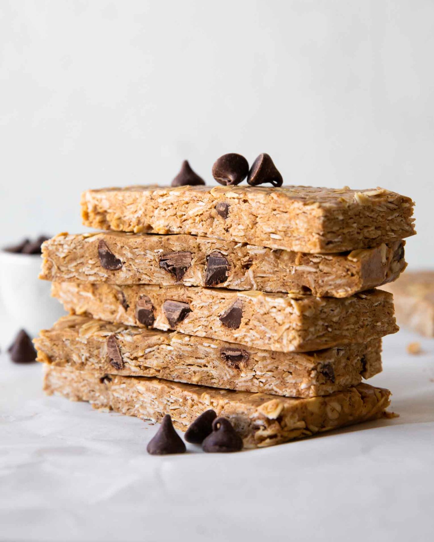 No-Bake Oatmeal Protein Bars stacked on parchment paper.