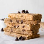 No-Bake Oatmeal Protein Bars stacked on parchment paper.