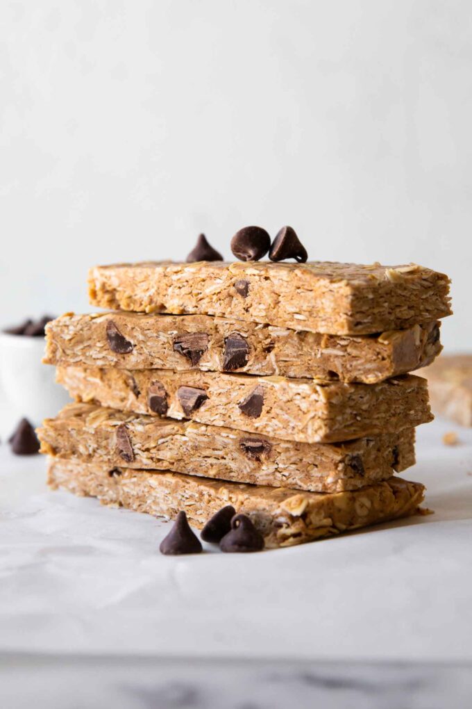 No-Bake Oatmeal Protein Bars stacked on parchment paper.