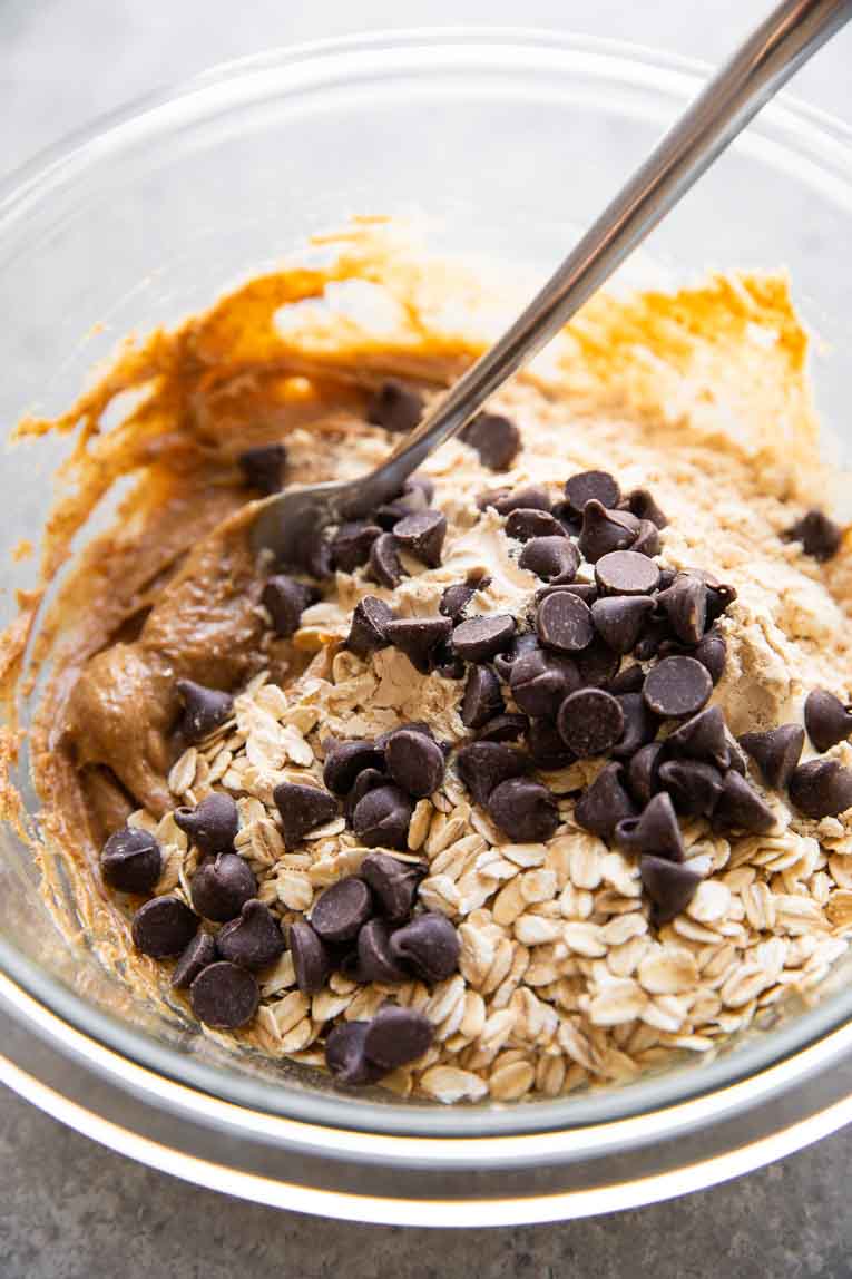 Protein bars being mixed in a glass bowl.