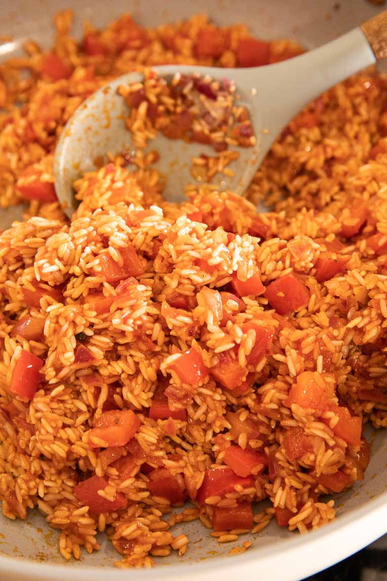 Spanish rice being cooked in pan.