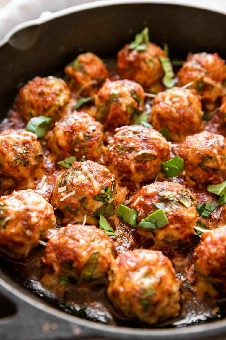 Angled photo of Baked Chicken Meatballs in a skillet.