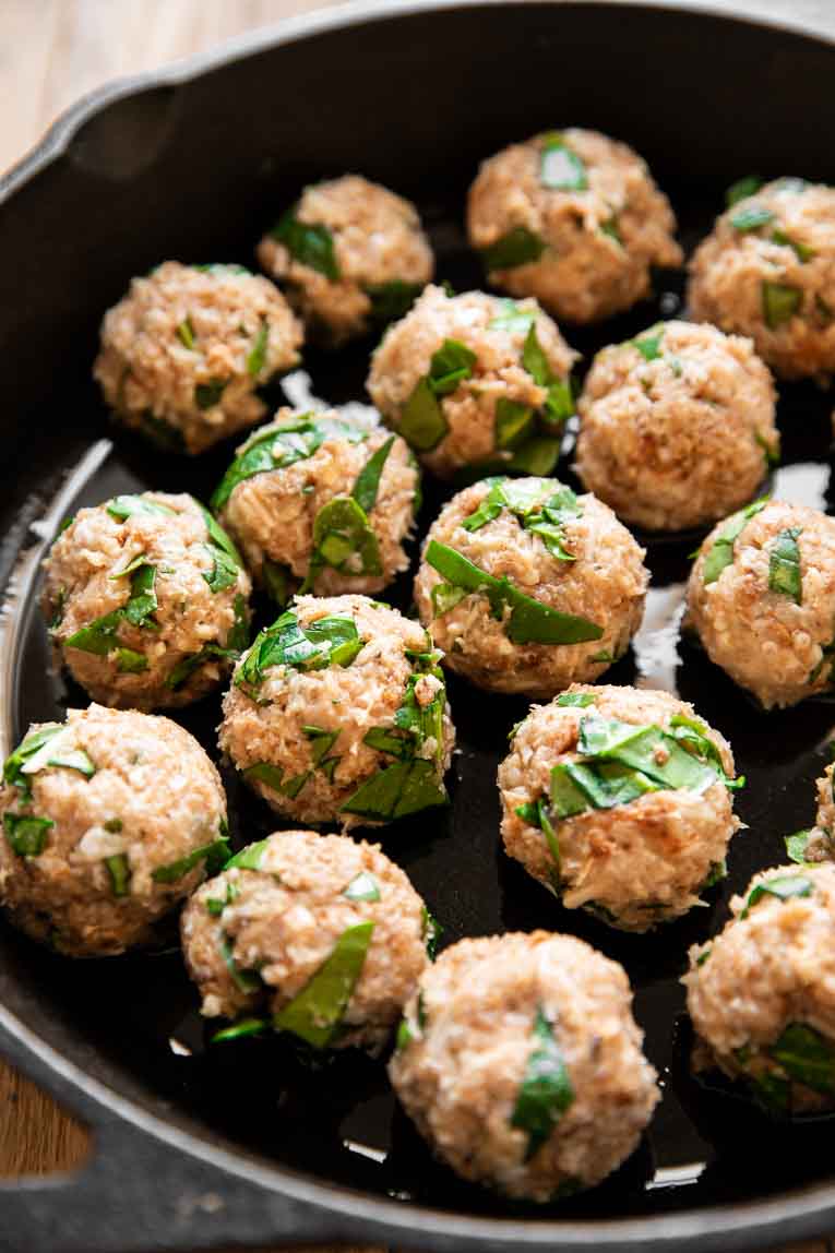 Spinach chicken meatballs in a casserole dish.