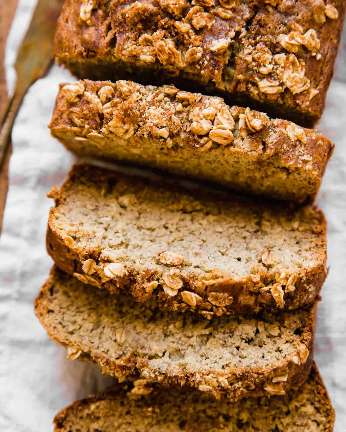 Healthy banana bread slices on a cutting board.