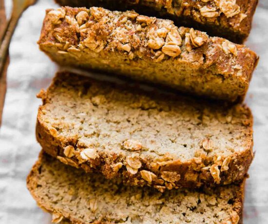 Healthy banana bread slices on a cutting board.