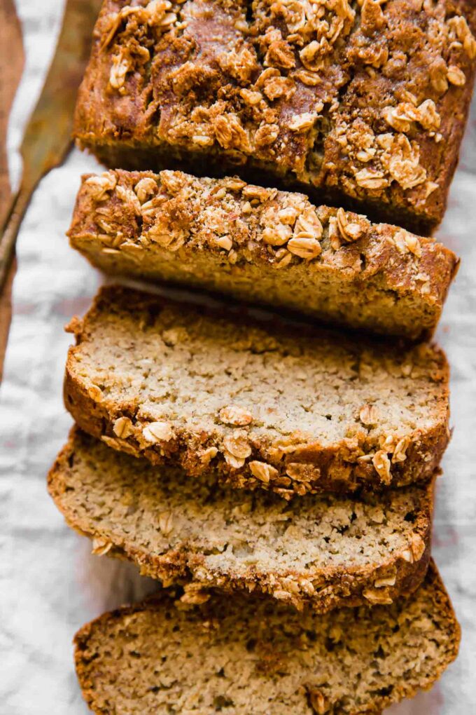 Healthy banana bread slices on a cutting board.