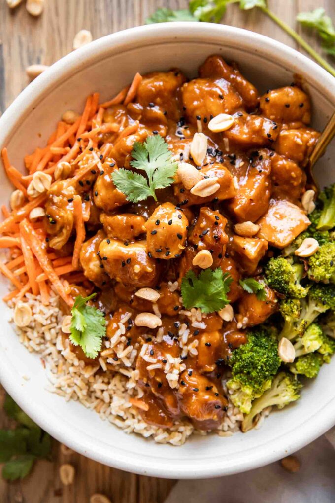Top photo of peanut butter chicken recipe in a large bowl.